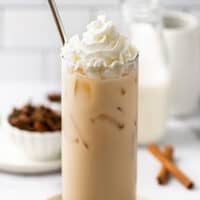 Iced chai tea latte in a glass cup.