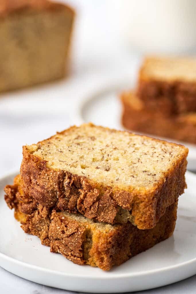 One banana banana bread slices on a white plate.