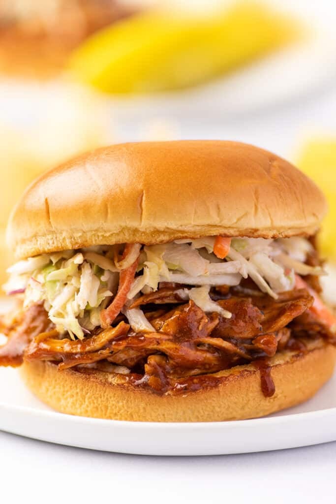 BBQ chicken sandwich on a white plate.