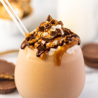 Chocolate peanut butter milkshake in a glass cup.