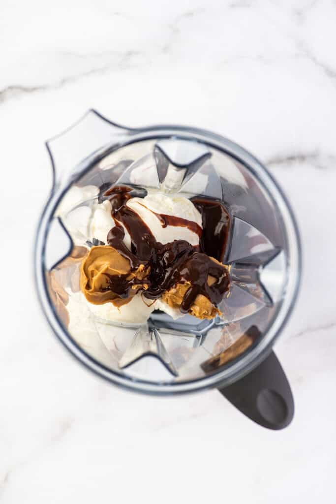 Chocolate peanut butter milkshake ingredients in a blender.