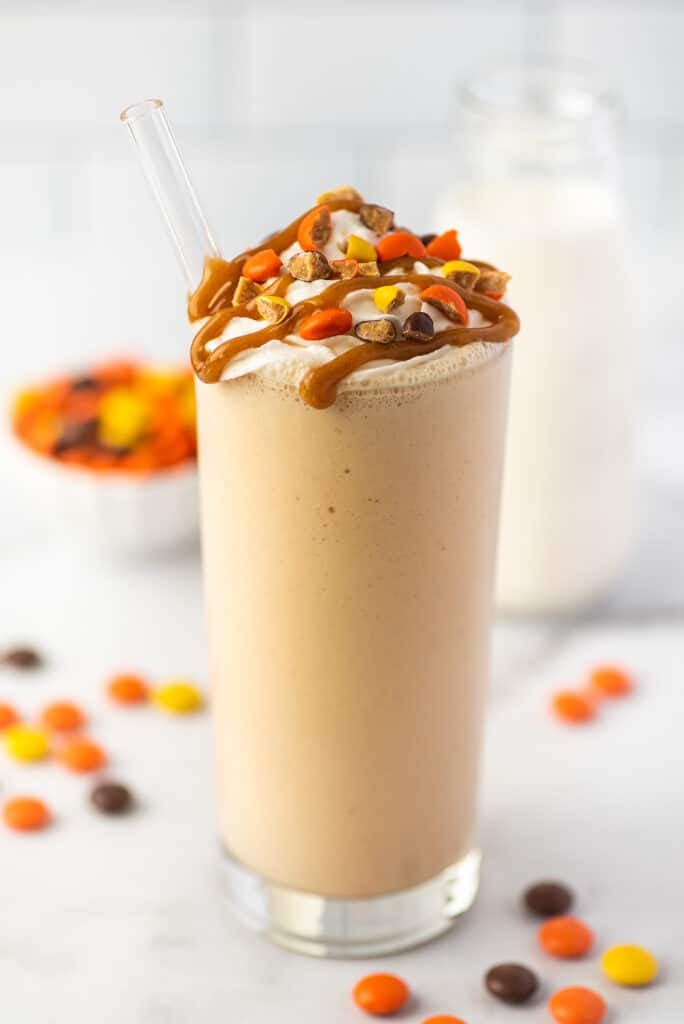 Peanut butter milkshake in a glass cup.