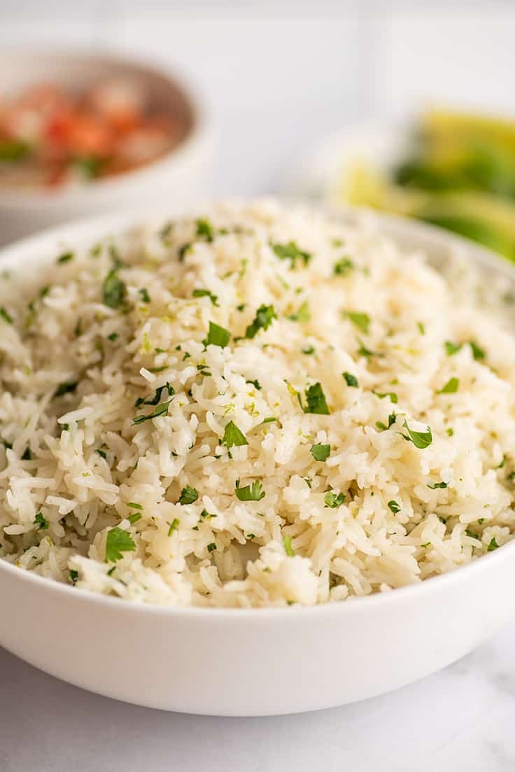 Cilantro lime rice in a large white bowl.