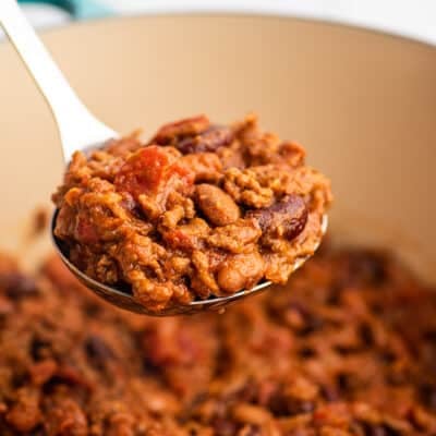 A ladle full of homemade chili.