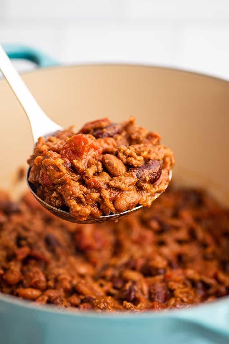A ladle full of homemade chili.