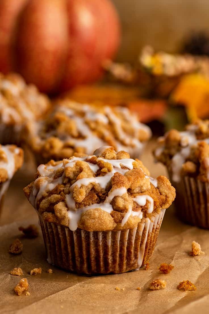 Pumpkin streusel muffins on parchment paper.