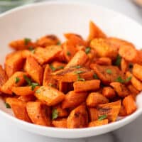 Roasted carrots in a white bowl.