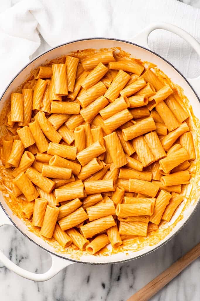 Pasta in vodka sauce in a white pot.
