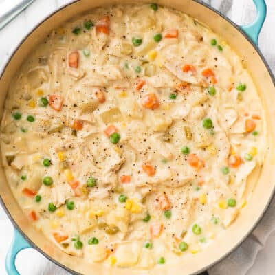 Chicken pot pie soup in a blue pot.