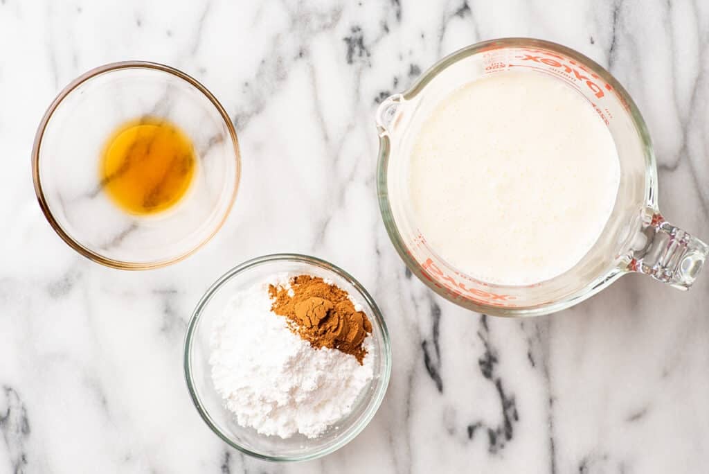 Cinnamon whipped cream ingredients on a counter.