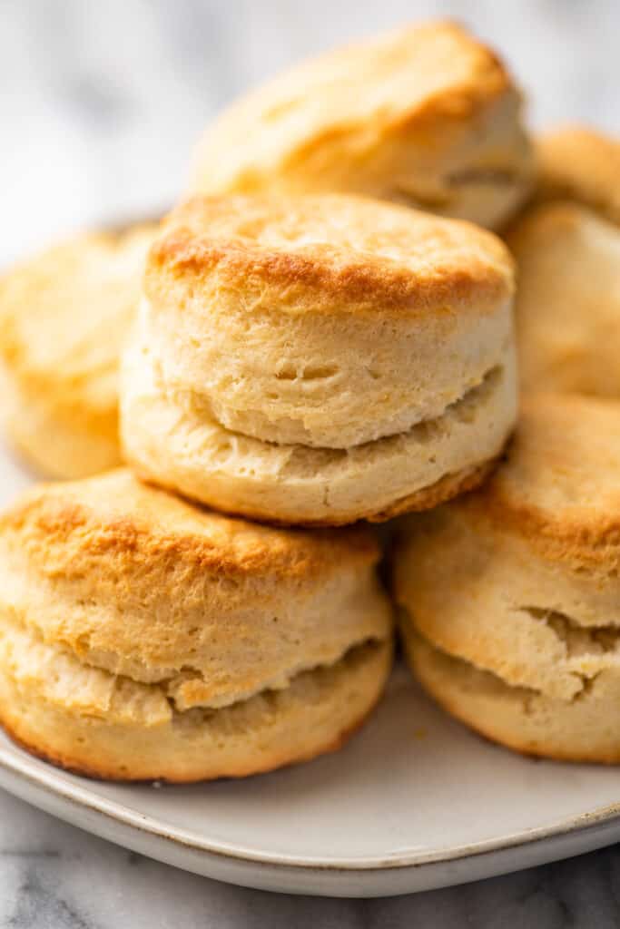 Cream biscuits stacked on a plate.