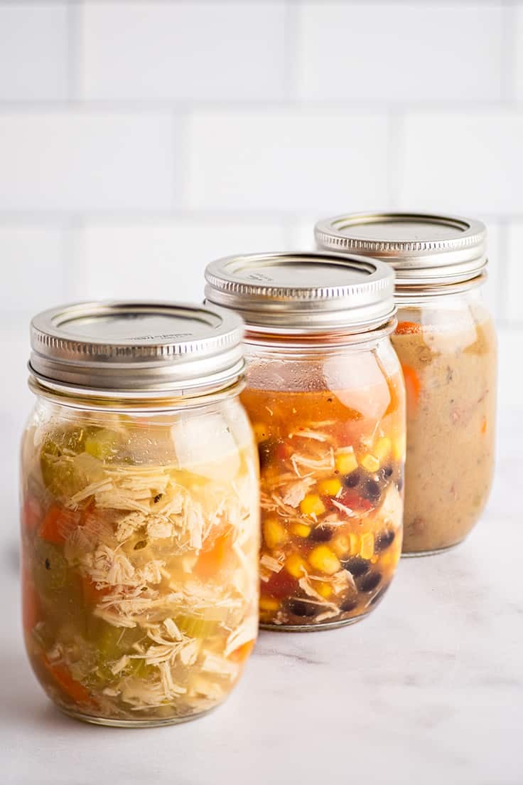 Mason jars of soup ready to be frozen.