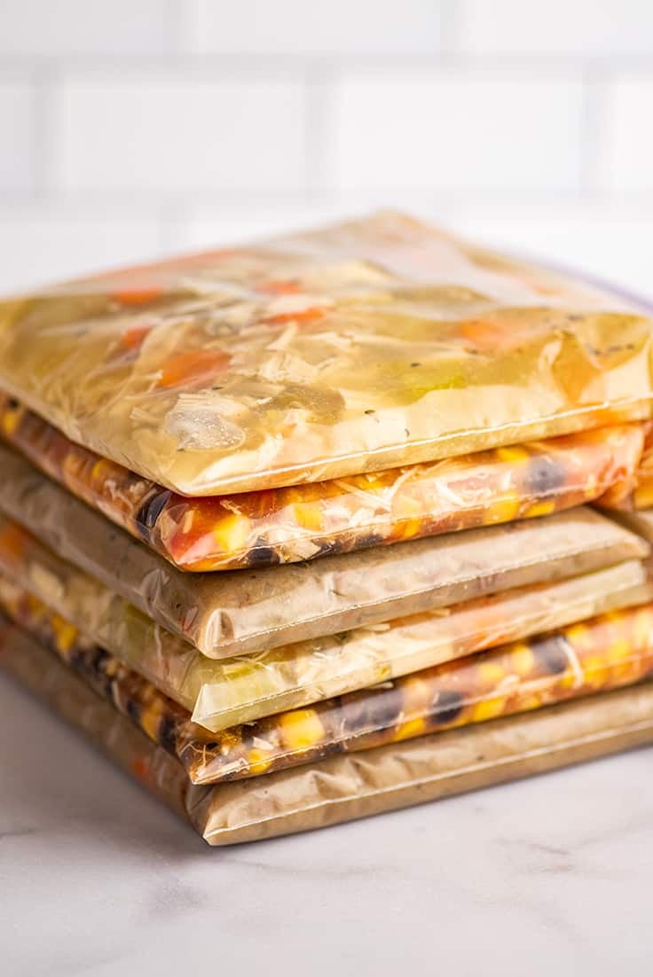 Bags of soup stacked and ready for freezing.