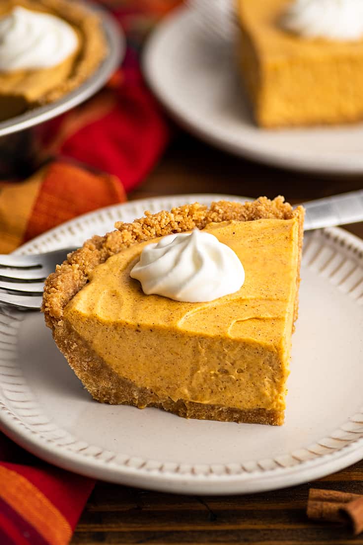 Slice of marshmallow pumpkin cheesecake on a white plate.