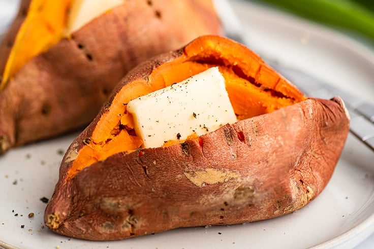 Microwave sweet potato cut open with butter and salt and pepper.