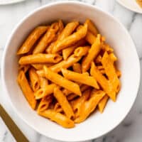 Penne alla vodka for one in a white bowl.