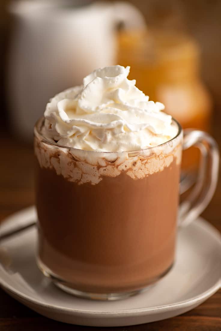 Salted caramel mocha in a glass mug with whipped cream.