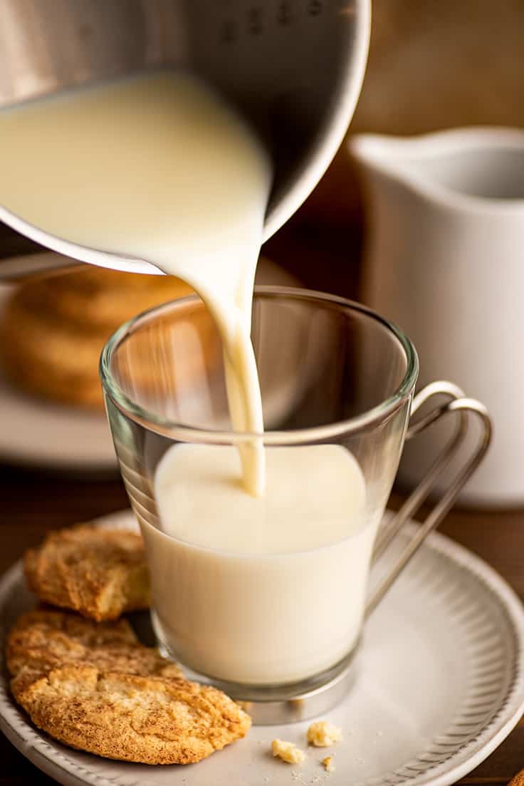 Snickerdoodle white hot chocolate being poured into a mug.
