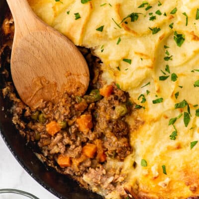 Cottage pie with ground beef filling in a cast iron pan.