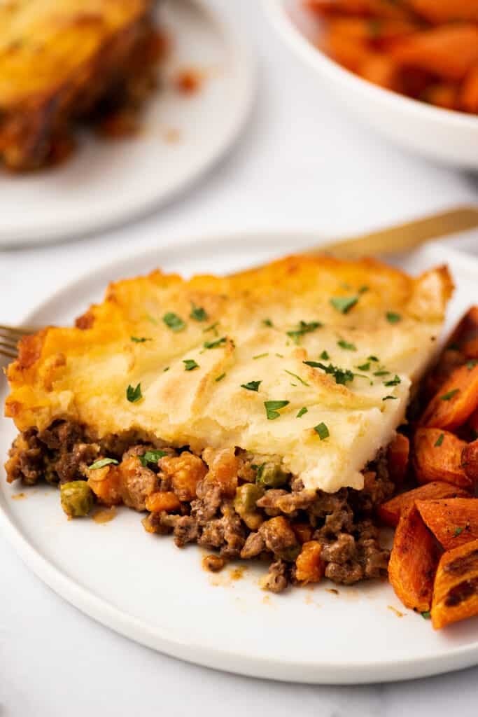 Slice of cottage pie on a plate.