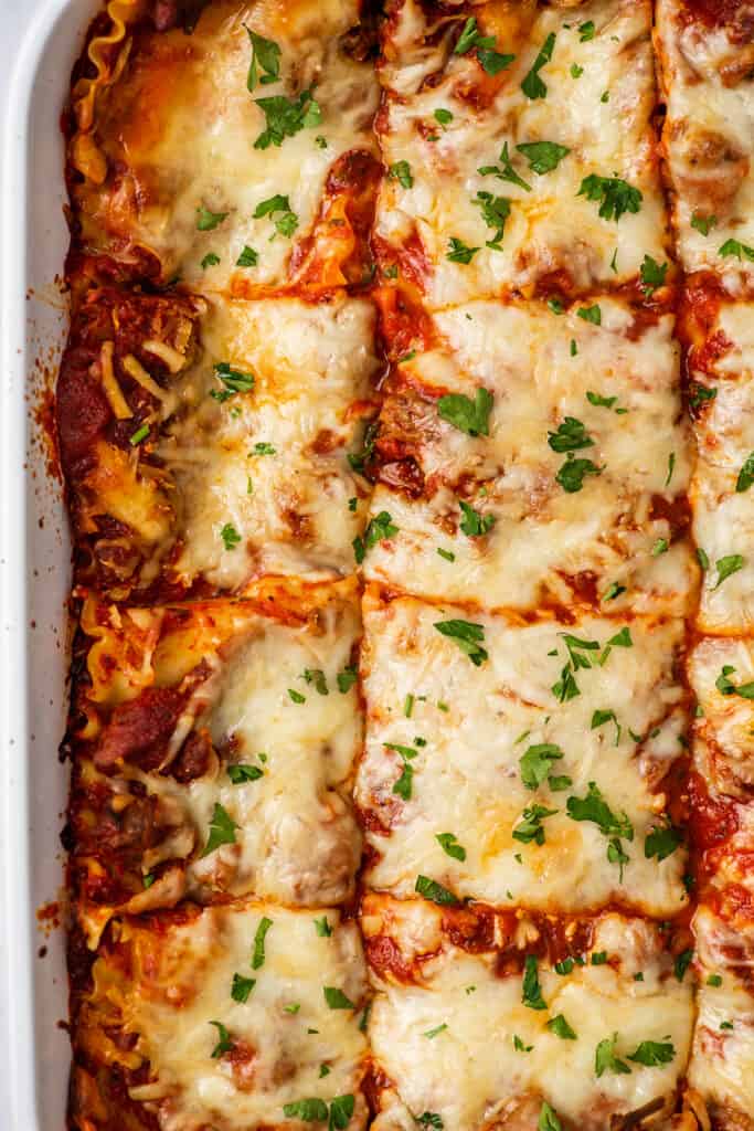 Close up photo of lasagna in a white dish.