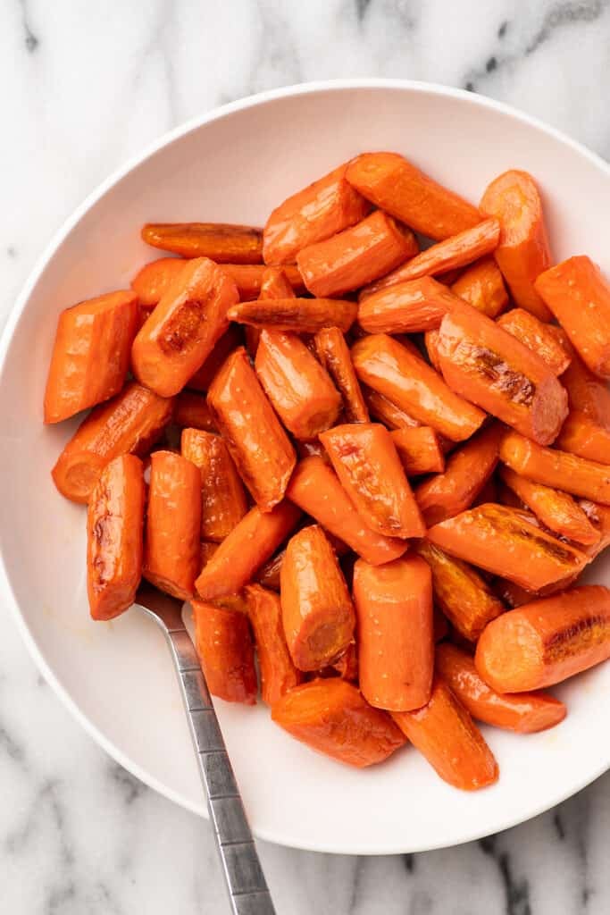 Honey roasted carrots in a white bowl.