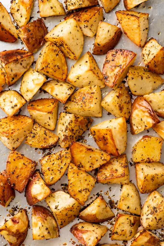 Crispy Italian roasted potatoes on a baking sheet.