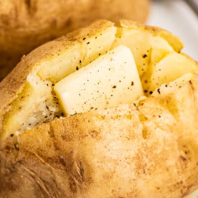 Microwave baked potato with butter.
