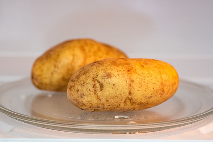 Potato in the microwave for cooking.