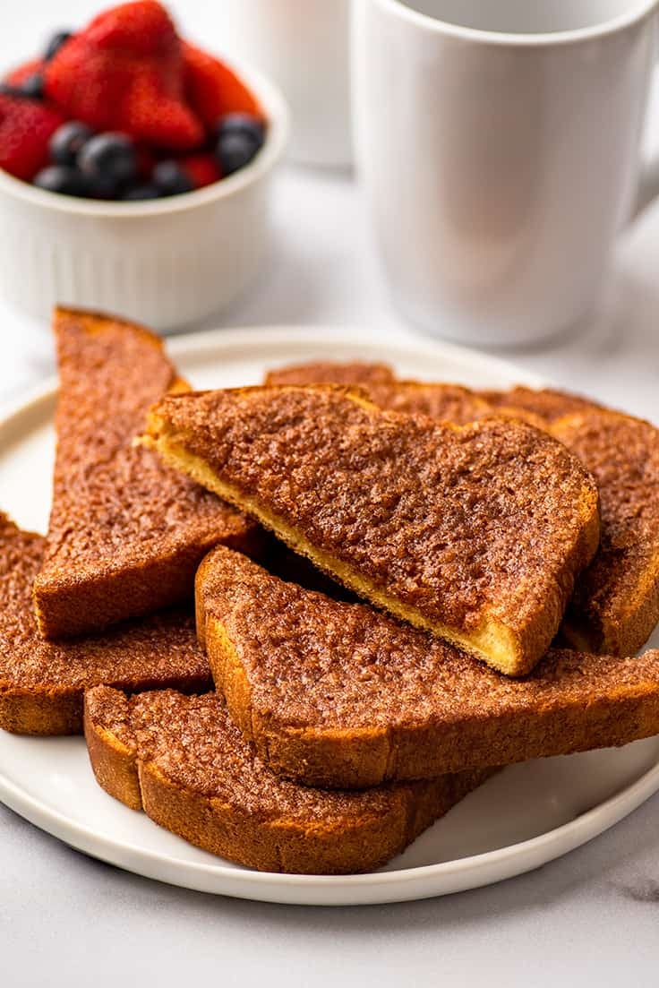 Cinnamon toast slices on a white plate.