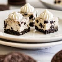 Three oreo cheesecake bites on a plate.