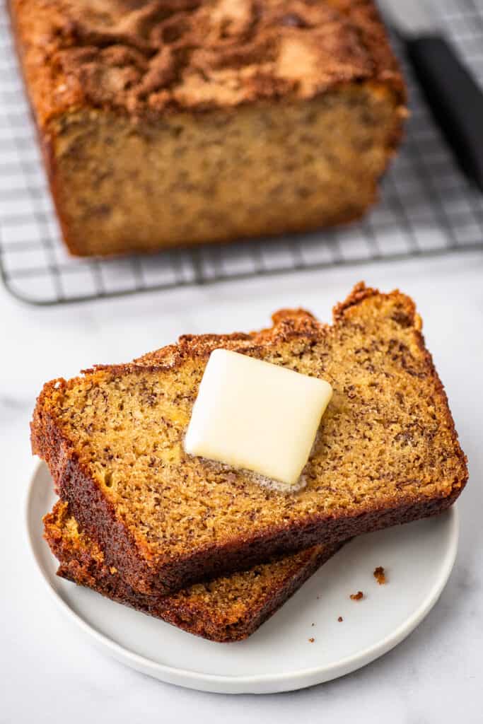 Slices of Dominique Ansel's banana bread recipe with butter.