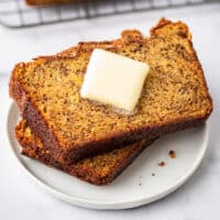 Slices of Dominique Ansel's banana bread recipe with butter.