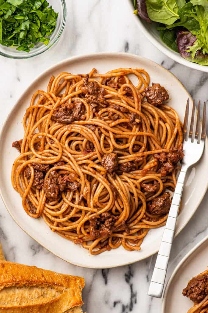 overhead shot of a plate of bolognese with a fork