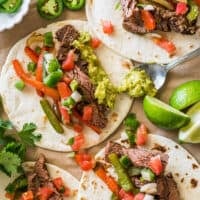 Overhead photo of steak fajitas on parchment paper.