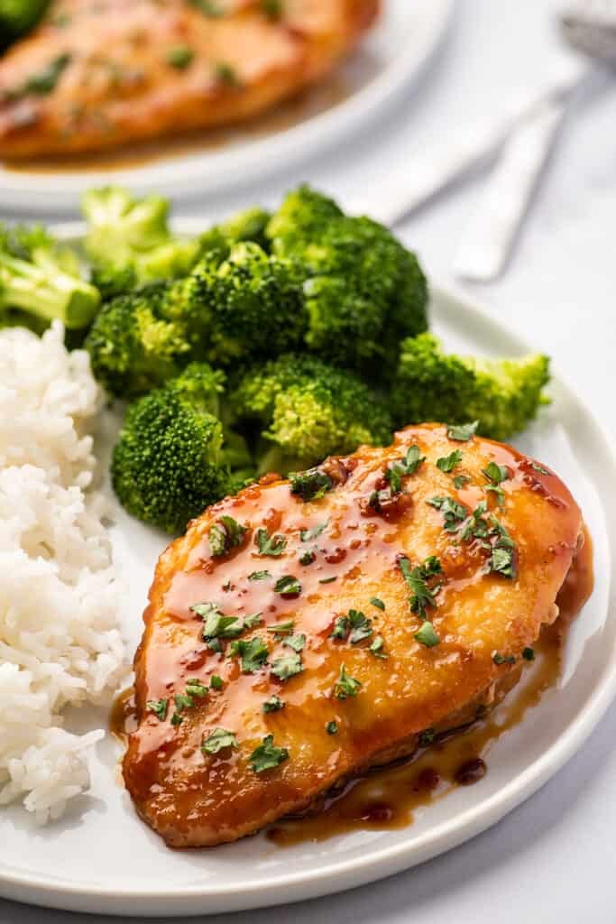 Piece of honey garlic chicken on a plate.