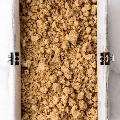 Streusel topping in a loaf pan before being baked.