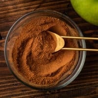 Apple pie spice in a bowl with a measuring spoon.
