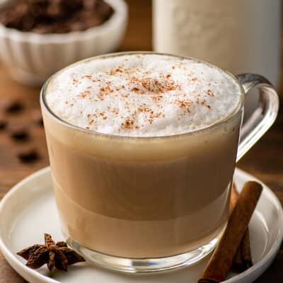 Dirty chai latte in a glass mug.