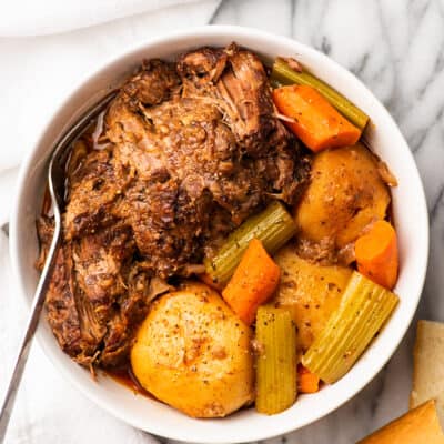 Red wine pot roast with vegetables in a serving bowl.