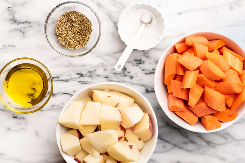 Ingredients for roasted carrots and potatoes on a counter