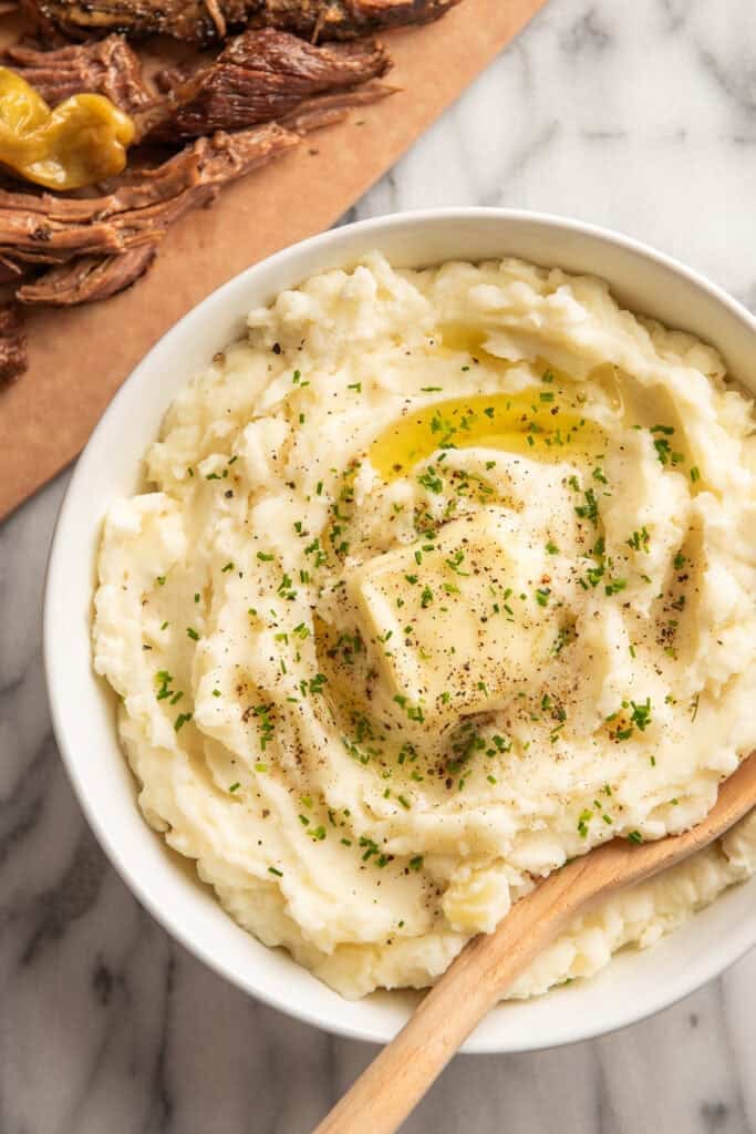 Sour cream mashed potatoes in a bowl with a spoon
