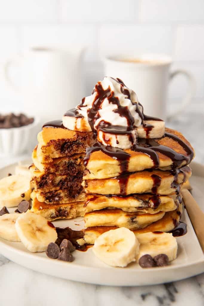 Chocolate chip pancakes with whipped cream and chocolate sauce